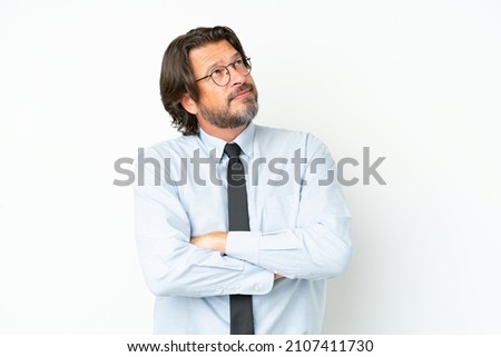 Senior dutch business man isolated on white background looking up while smiling