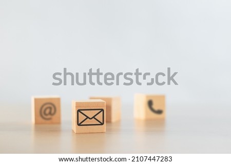 wooden cube block with icons e-mail, contact us, telephone. online communication concept. service business connection network.