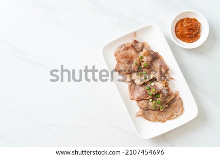 grilled pork neck sliced on plate in Asian style