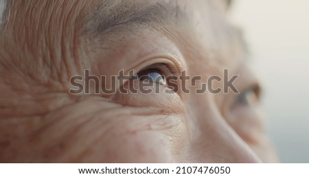 close up shot of asian old man eye Royalty-Free Stock Photo #2107476050