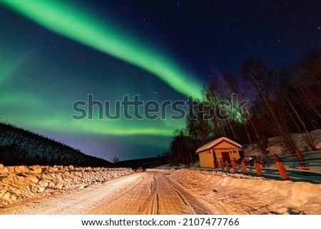 Beauitful aurora over the night sky, wooden house at Fairbanks, Alsaka