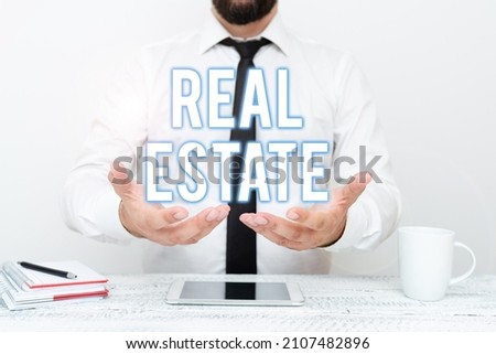 Hand writing sign Real Estate. Internet Concept total property consisting of both natural resource and building Presenting Communication Technology Smartphone Voice And Video Calling