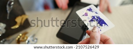 Close-up of terminal and person with white plastic credit card. Cashier machine to withdrawals money. Nfc technology. Finance and cashless way to pay for purchase. Contactless payment concept
