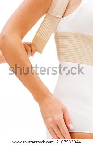 Instruction how to wear posture corrector.  Vertical photo on white background