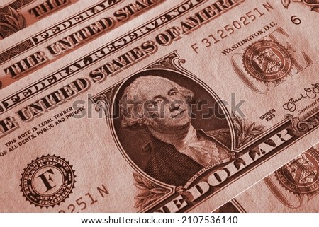 American money close-up. 1 US dollar bills with textured paper surface. Economy and business of the USA. Federal reserve note. Brown tinted background or wallpaper. Macro