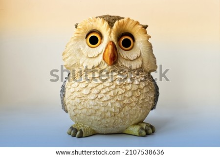 Statue of an Owl isolated on bright background.