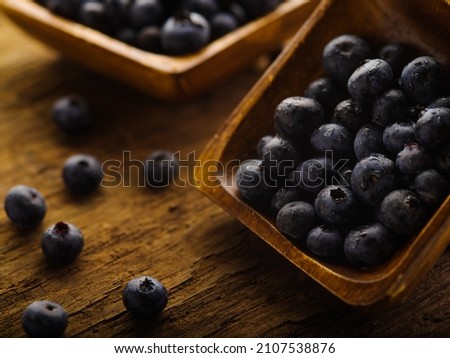 Blueberries in bowls and in bulk on the table. Close-up. Vitamins, antioxidants, vegan food. Ingredient for various dishes and drinks. Banner, poster, advertising.