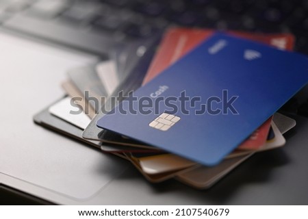 Credit and deposit cards on a computer keyboard. Electronic commerce, business. Online shopping, new technologies in finance, economics and trade. Close-up. There are no people in the photo.