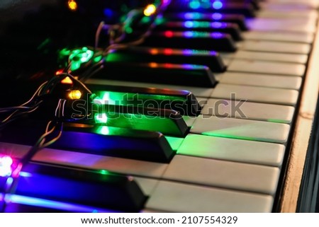 Glowing colorful lights on piano, closeup