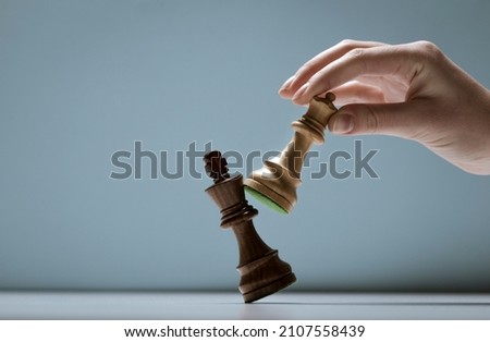 Player defeating the king and winning a chess game, strategy and tactics concept Royalty-Free Stock Photo #2107558439
