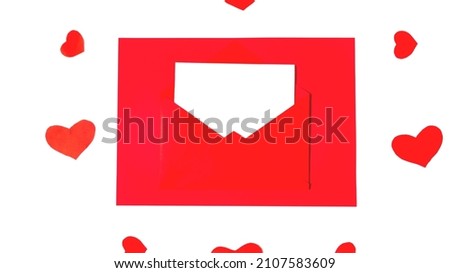 Red paper envelope with blank white note mockup inside on white background. Flat lay, top view. Romantic love letter for Valentine's day concept. Space for text