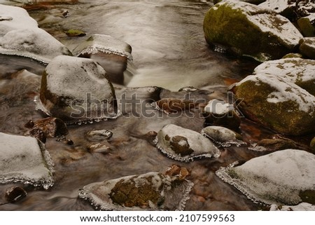 Mumlava river in Krkonoše national park . mountain stream in winter.