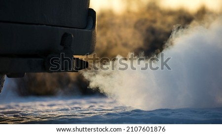 white smoke from car exhaust in cold weather Royalty-Free Stock Photo #2107601876