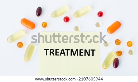 Treatment inscription on a yellow card on a white background around the card lie tablets