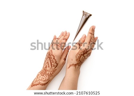 Beautiful female hands with henna tattoo on white background Royalty-Free Stock Photo #2107610525