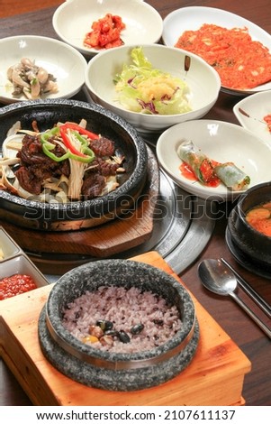 Seokgalbi is a Korean food that you cook galbi and put it on a warm stone plate. Royalty-Free Stock Photo #2107611137
