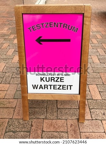 German language sign outside corona covid testzentrum. Translation: Test centre - quick test in 15 minutes - short waiting time