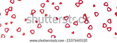 Banner Valentine's Day background February 14th. Red hearts confetti on white background. Valentines day creative concept. Flat lay, top view, copy space