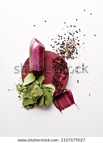 Concept of professional makeup, beauty, decorative cosmetics.  Abstract composition of spilled and scattered makeup texture. Colourful beauty products for makeup artists. Top view, design element.