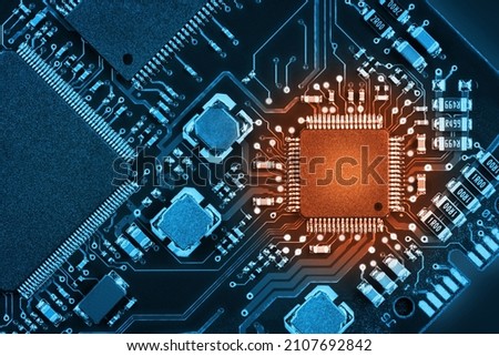 Processor on a printed circuit board. Abstract technological background. Tinted in two colors Royalty-Free Stock Photo #2107692842