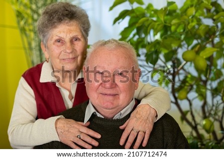 Picture of a joyful and happy elderly couple at home