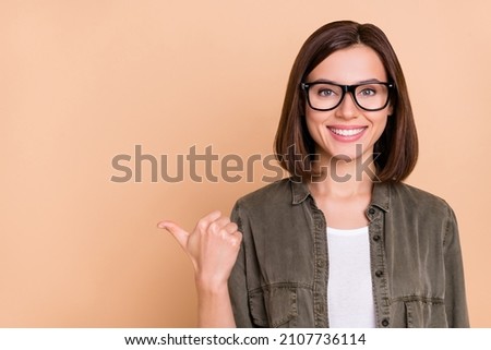 Photo of promoter lady direct thumb empty space novelty sale wear khaki shirt isolated beige color background
