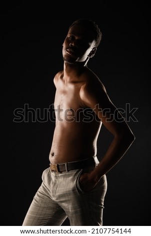Silhouette of black male is posing while looking at the camera