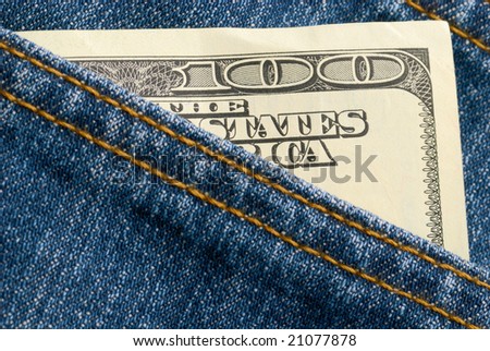 Hundred dollar bill sticks out of a pocket