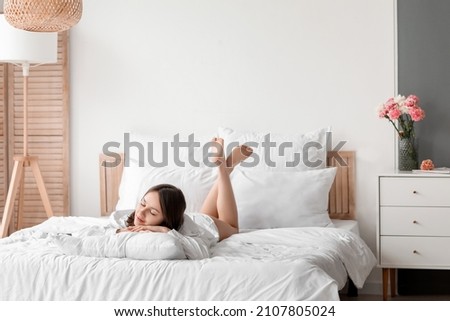 Young woman sleeping in bedroom Royalty-Free Stock Photo #2107805024