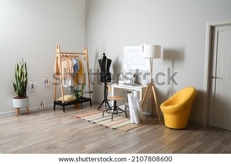 Tailor's workplace with mannequin in modern atelier Royalty-Free Stock Photo #2107808600