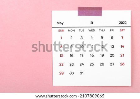 The May 2022 calendar on pink background.
