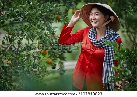 Sa Dec city, VietNam: Western girl portrait in ripe tangerine garden Royalty-Free Stock Photo #2107810823