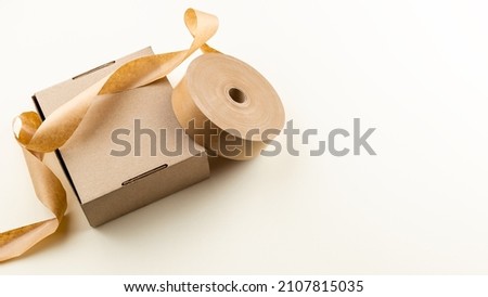Biodegradable eco friendly paper sticky tape for cardboard box. Natural packing materials Royalty-Free Stock Photo #2107815035