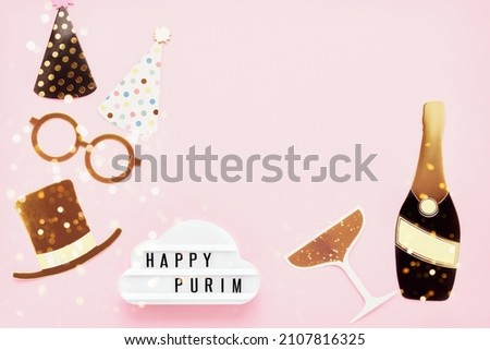Jewish holiday Purim concept. Fun party props and lightbox with Happy Purim on a light pink background. Flat lay, copy space for text