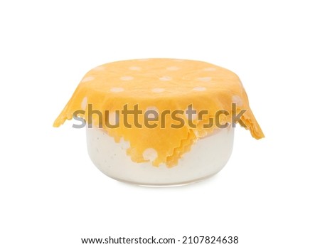 Jar of sauce covered with beeswax food wrap isolated on white Royalty-Free Stock Photo #2107824638