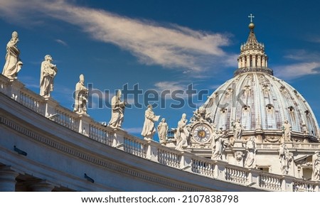 Statues of Catholic Saints. Decorations on Bernini colonnade, Saint Peter Cathedral, with the Cupola in background - Rome, Italy Royalty-Free Stock Photo #2107838798