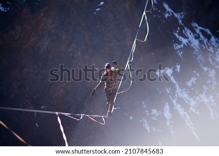A daredevil balancing high over a lake on a beautiful winter day Royalty-Free Stock Photo #2107845683