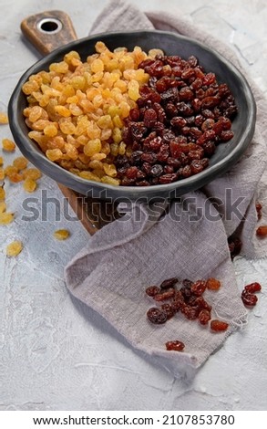 Golden and brown raisins on light  background. Dried Fruits. 