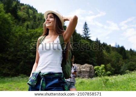 Happy young woman hiker hiking portrait with backpack. Fresh and healthy lifestyle. Royalty-Free Stock Photo #2107858571