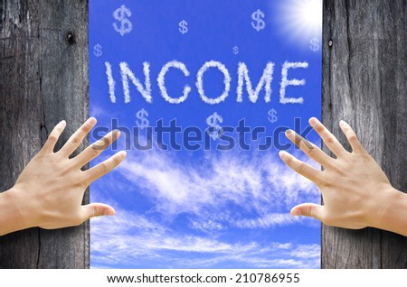 Hand opening the wooden door and see "INCOME" text cloud in the Sky.