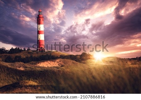 Lighthouse on Amrum at sunset with dramatic clouds