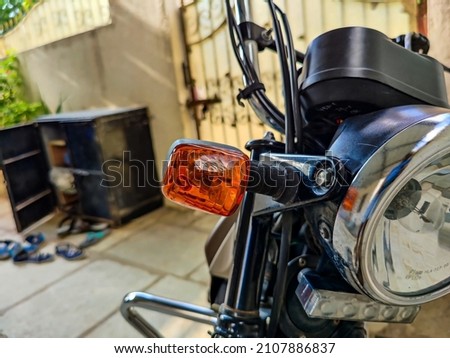 Extreme close up of motorbikes headlight and indicator, motorbike parked at home in the afternoon at Gulbarga Karnataka, India. focus on headlight.