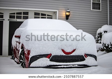 Snow on a red car Royalty-Free Stock Photo #2107887557