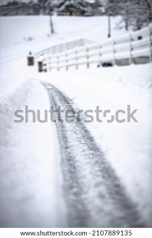 Tire tracks in the snow Royalty-Free Stock Photo #2107889135