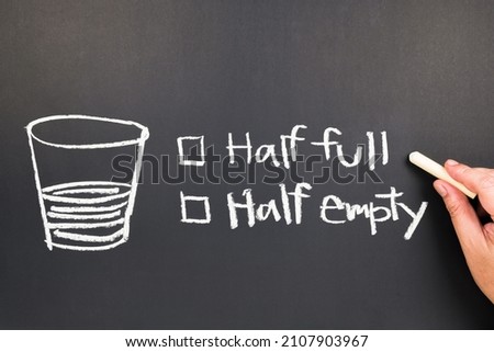 Hand draw a half full glass concept with choices on chalkboard, half full or half empty water glass, optimist and pessimist of attitude or mindset Royalty-Free Stock Photo #2107903967
