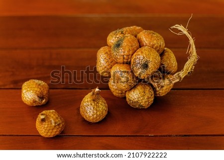 Wild salak fruit on wooden table
