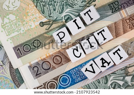 The wording "PIT, CIT, VAT"  translated as "Personal Income Tax"  , "Company Income Tax" , "Value Added Tax  plus many Polish banknotes. New tax rules in Poland at 2022. 