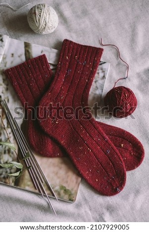 Hand knitting socks with needles and yarn balls.  Concept for handmade and hygge slow life.  