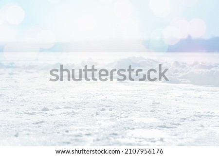 WHITE SNOW AND ICE WITH BOKEH LIGHTS, OUTDOOR FROSTY WINTER BACKGROUND WITH EMPTY SPACE FOR MONTAGE