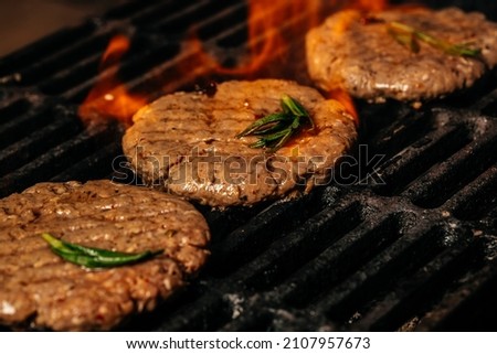 American cuisine. The concept cooking meat. pieces of beef steaks from grill. concept cooking meat with smoke, spices and rosemary.